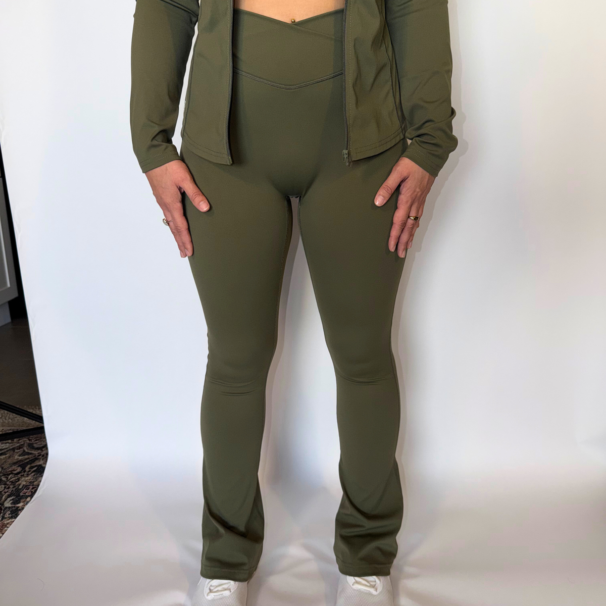 Person wearing a green athletic outfit on a white background