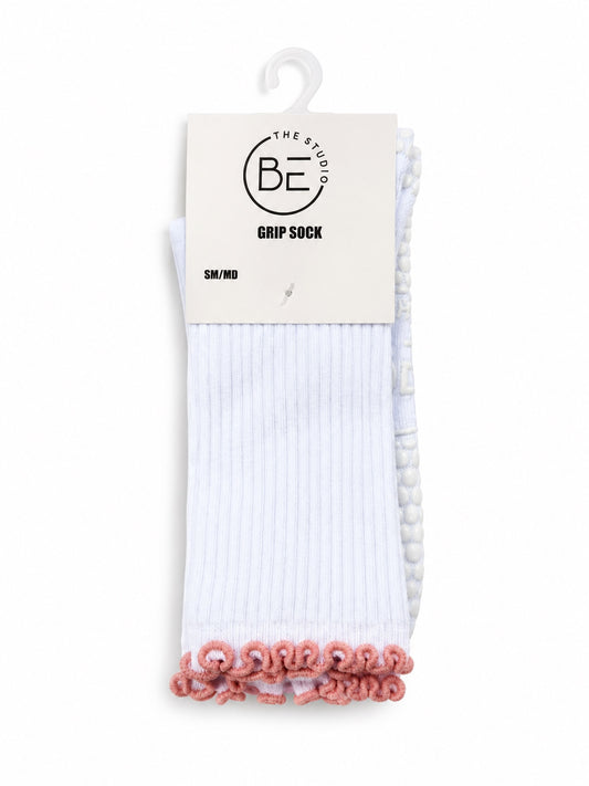 White grip socks with coral ruffle trim